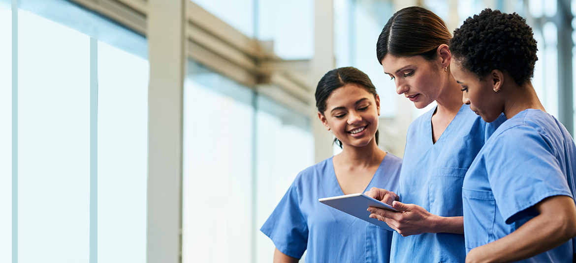 Shot of a group of medical practitioners using a digital tablet together in a hospital