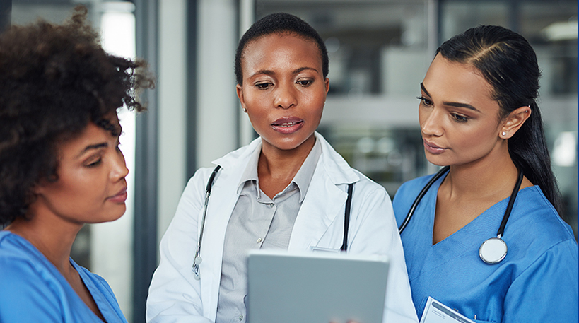 Shot of a group of medical practitioners working together on a digital tablet in a hospital