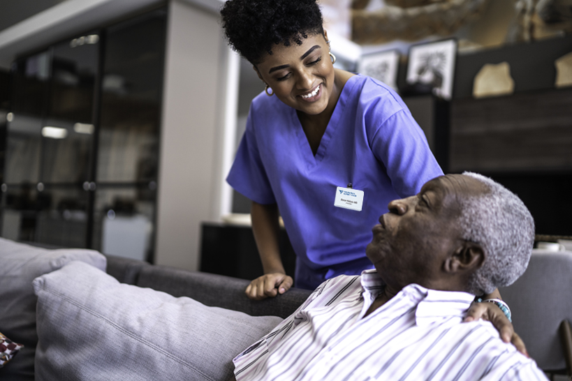 Female nurse taking care of a senior man at home