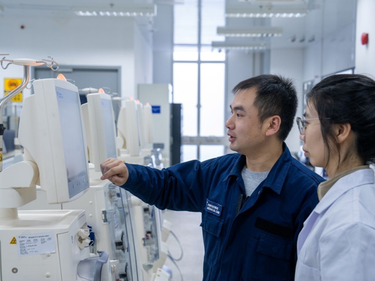 FME technician showing nurse dialysis machine
